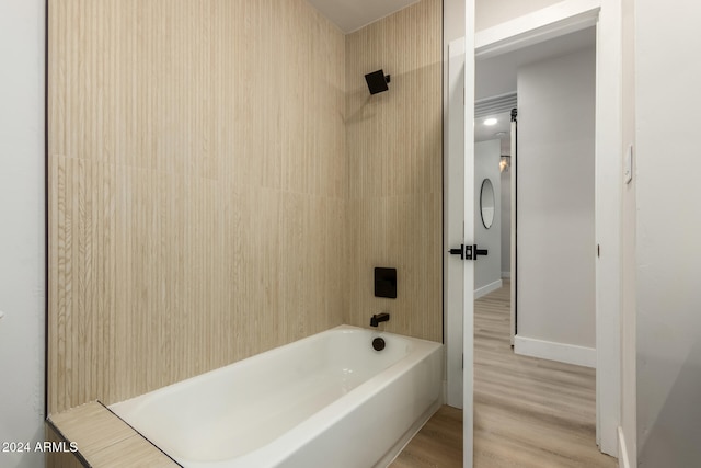 bathroom featuring shower / bathing tub combination and hardwood / wood-style floors