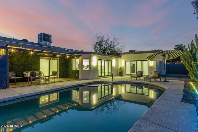 pool at dusk with central AC unit, an outdoor living space, a patio area, and an in ground hot tub