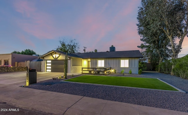 ranch-style home with a yard and a garage