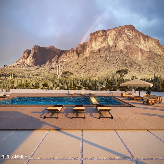 view of swimming pool with a deck with mountain view