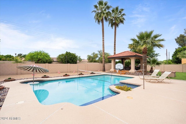 view of pool with a patio area, a fenced backyard, a fenced in pool, and a gazebo