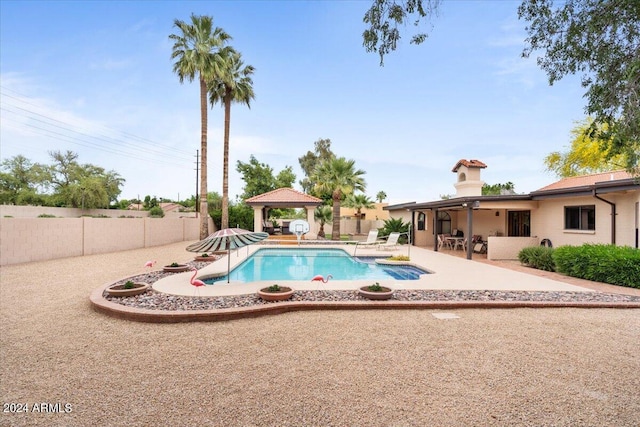 view of pool featuring a fenced in pool, a patio area, a fenced backyard, and a gazebo