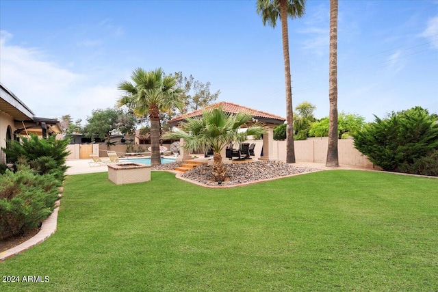 view of yard with a fenced backyard, a fenced in pool, and a patio