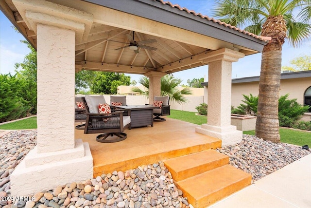 view of patio with an outdoor hangout area, a gazebo, fence, and a ceiling fan