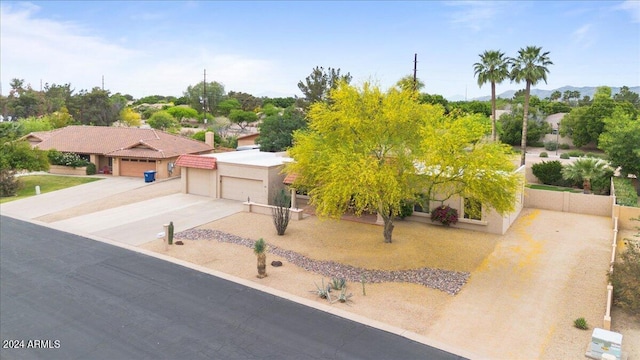 view of front of house with a garage, concrete driveway, and stucco siding