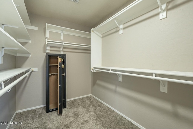 walk in closet with carpet