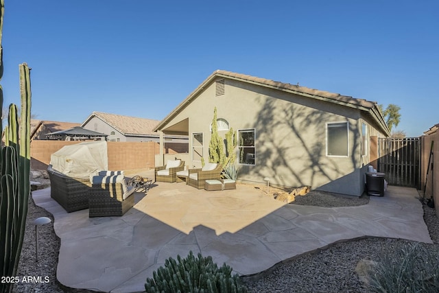 rear view of house featuring a patio and outdoor lounge area