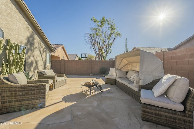 view of patio featuring an outdoor living space with a fire pit