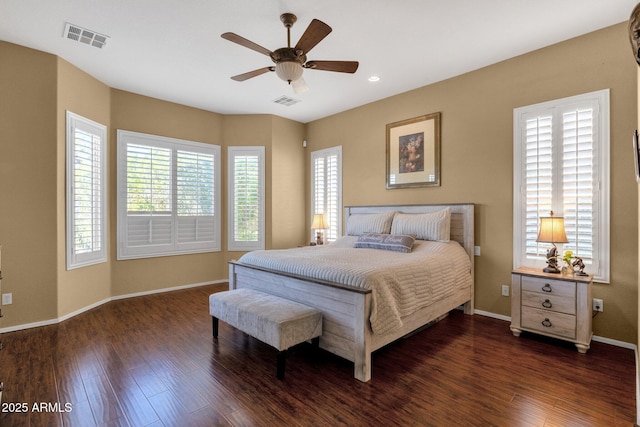 bedroom featuring a ceiling fan, visible vents, baseboards, and dark wood-type flooring