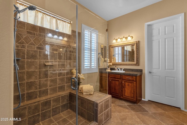 full bath featuring tile patterned floors, a stall shower, and vanity
