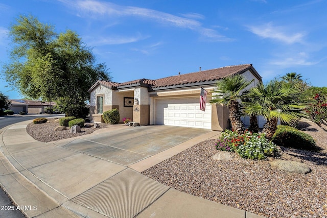 mediterranean / spanish-style house with a tile roof, driveway, an attached garage, and stucco siding