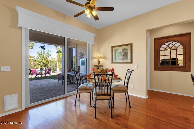 dining area with visible vents, hardwood / wood-style floors, ceiling fan, and baseboards