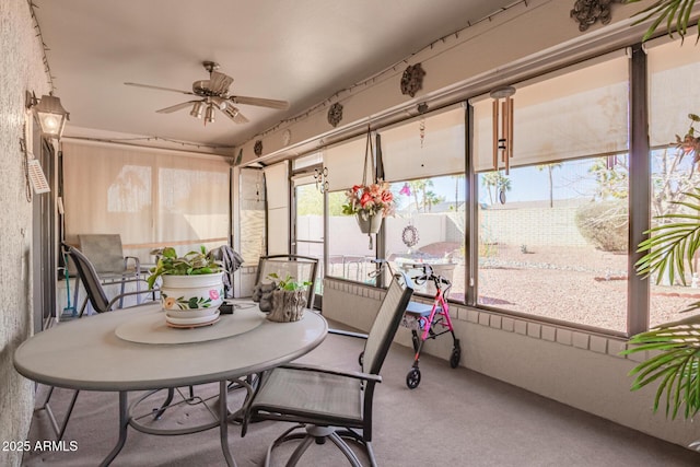 sunroom with a ceiling fan