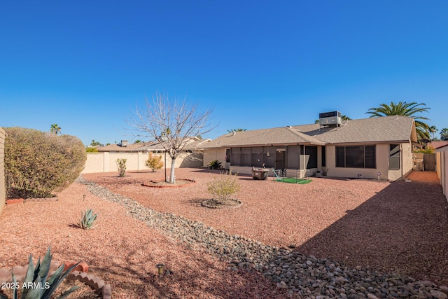 rear view of property with a sunroom, a fenced backyard, and a patio