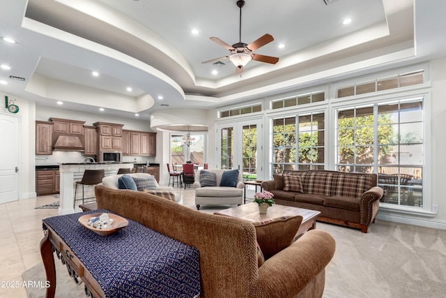 living room with a tray ceiling and a high ceiling