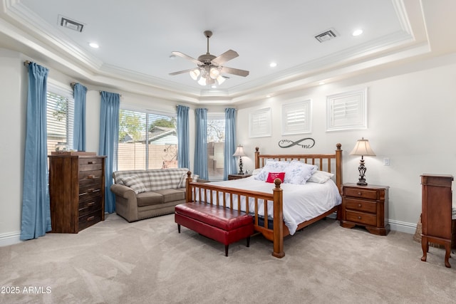 carpeted bedroom with crown molding, ceiling fan, and a tray ceiling