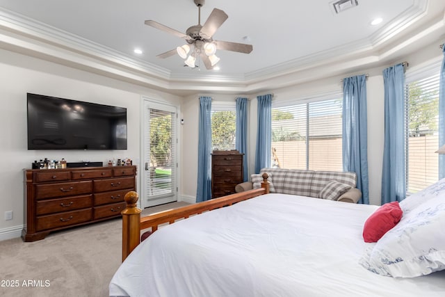 bedroom featuring light colored carpet, ornamental molding, a tray ceiling, and access to exterior