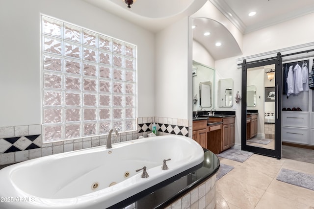 bathroom with vanity, tiled tub, and ornamental molding