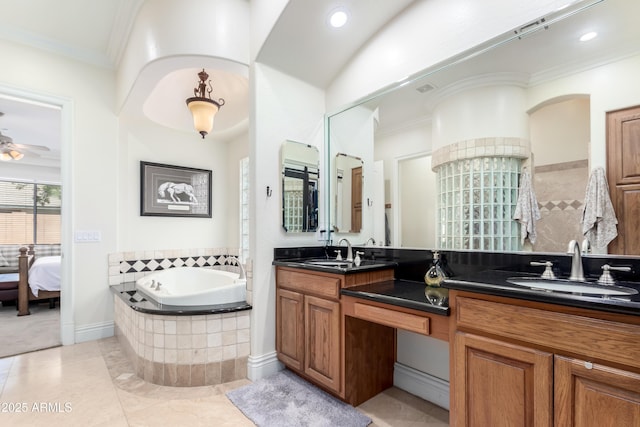 bathroom with crown molding, ceiling fan, vanity, and tiled bath