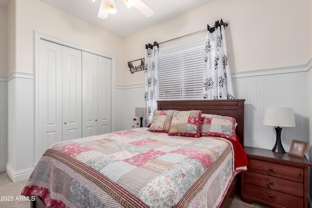 bedroom with a closet, ceiling fan, and carpet