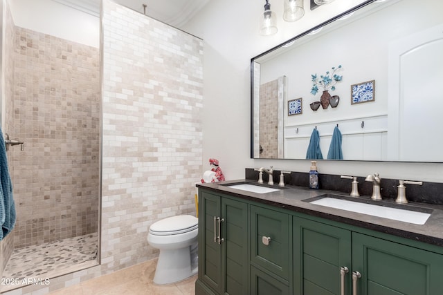 bathroom with vanity, tile patterned floors, toilet, and tiled shower