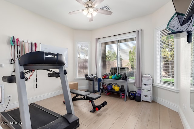 exercise area with light wood-type flooring and ceiling fan