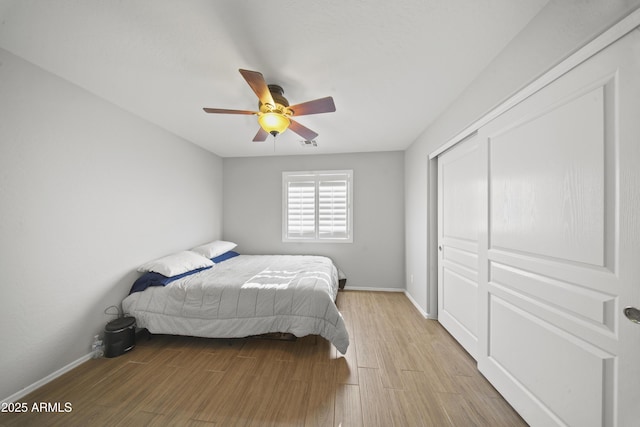 9719 W Heber Rd, Tolleson, AZ 85353 - bedroom featuring baseboards, ceiling fan, light wood finished floors, and a closet