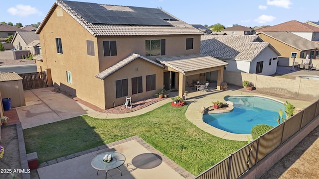 9719 W Heber Rd, Tolleson, AZ 85353 - rear view of property featuring a tile roof, a patio area, roof mounted solar panels, a fenced backyard, and stucco siding