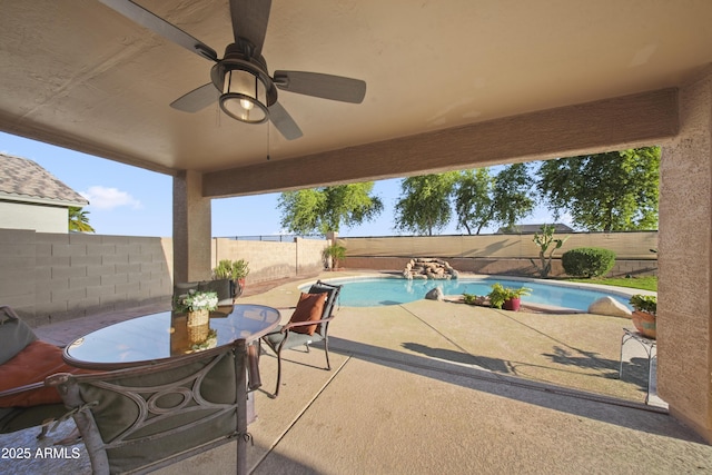 9719 W Heber Rd, Tolleson, AZ 85353 - view of patio / terrace featuring ceiling fan, a fenced in pool, a fenced backyard, and outdoor dining space