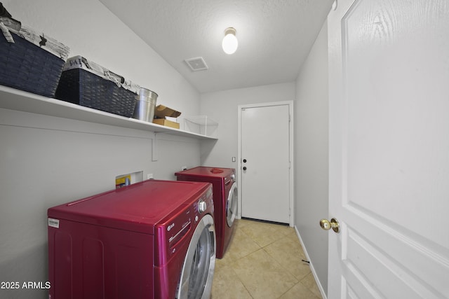 9719 W Heber Rd, Tolleson, AZ 85353 - laundry area featuring laundry area, visible vents, baseboards, washing machine and clothes dryer, and light tile patterned floors