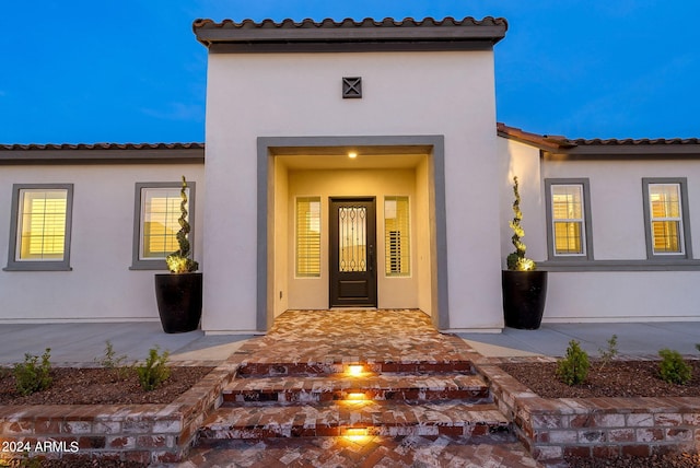 doorway to property with stucco siding