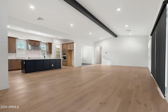 unfurnished living room featuring vaulted ceiling with beams, light wood-style flooring, visible vents, and recessed lighting