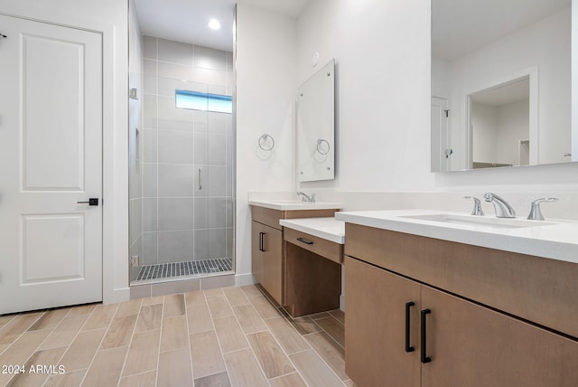 bathroom featuring a shower stall, wood finish floors, and vanity