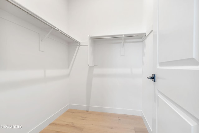 walk in closet featuring light wood-style flooring