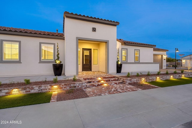 mediterranean / spanish-style house with a tiled roof and stucco siding