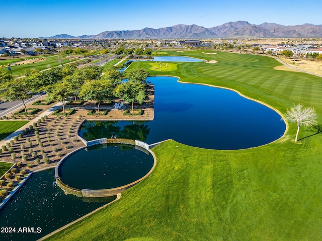 drone / aerial view with golf course view and a water and mountain view