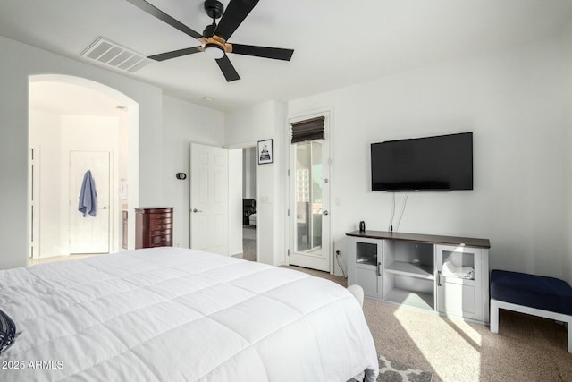 bedroom featuring visible vents, arched walkways, ceiling fan, access to exterior, and carpet