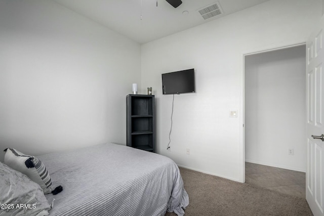 carpeted bedroom featuring visible vents, ceiling fan, and baseboards