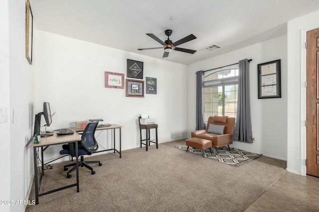 office space with carpet, visible vents, and a ceiling fan