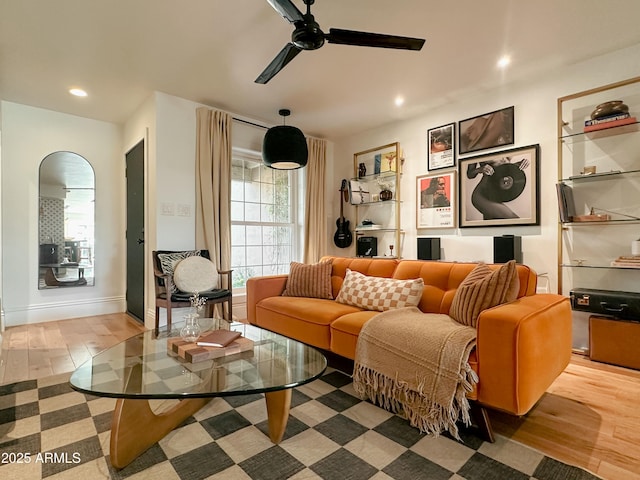 living room featuring ceiling fan and light hardwood / wood-style flooring