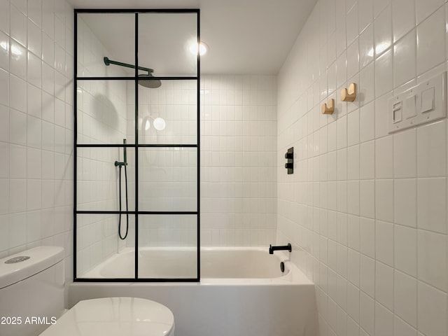 bathroom featuring enclosed tub / shower combo, tile walls, and toilet