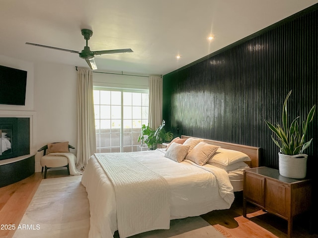 bedroom featuring light hardwood / wood-style flooring and ceiling fan