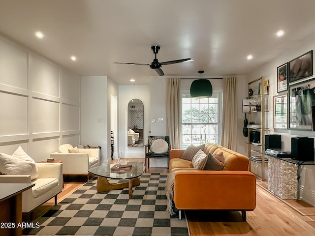 living room with light hardwood / wood-style floors and ceiling fan