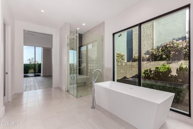 6970 E Joshua Tree Ln, Paradise Valley, AZ 85253 - bathroom featuring a freestanding bath, a stall shower, recessed lighting, and baseboards