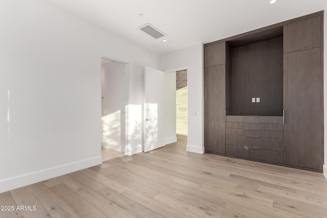 6970 E Joshua Tree Ln, Paradise Valley, AZ 85253 - unfurnished bedroom with light wood-style floors, baseboards, and recessed lighting