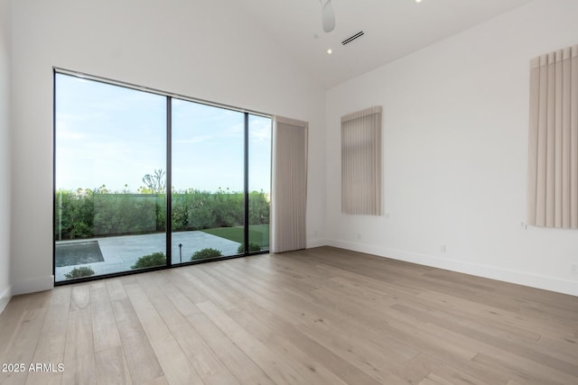 6970 E Joshua Tree Ln, Paradise Valley, AZ 85253 - spare room featuring high vaulted ceiling, light wood-style floors, baseboards, and a ceiling fan