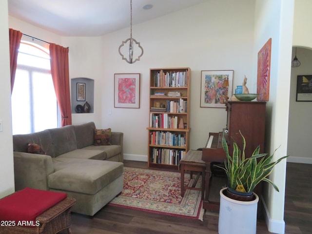 interior space with a notable chandelier, baseboards, and wood finished floors