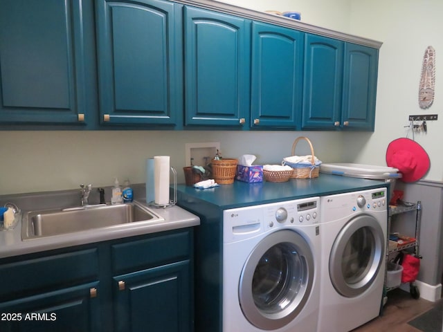 washroom with independent washer and dryer, a sink, and cabinet space