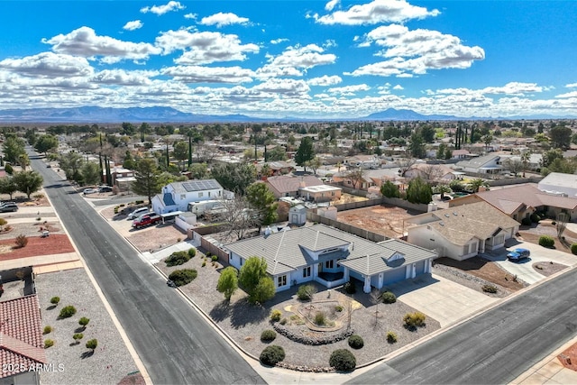 drone / aerial view featuring a residential view and a mountain view