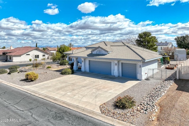 view of front of house featuring an attached garage, fence, a tiled roof, driveway, and stucco siding